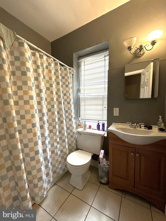 bathroom featuring tile patterned flooring, vanity, and toilet