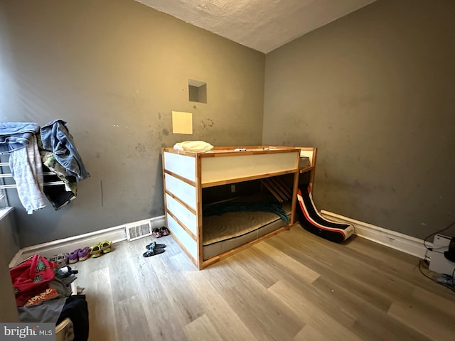 bedroom with hardwood / wood-style flooring