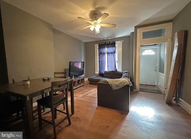 living room featuring ceiling fan and light hardwood / wood-style flooring