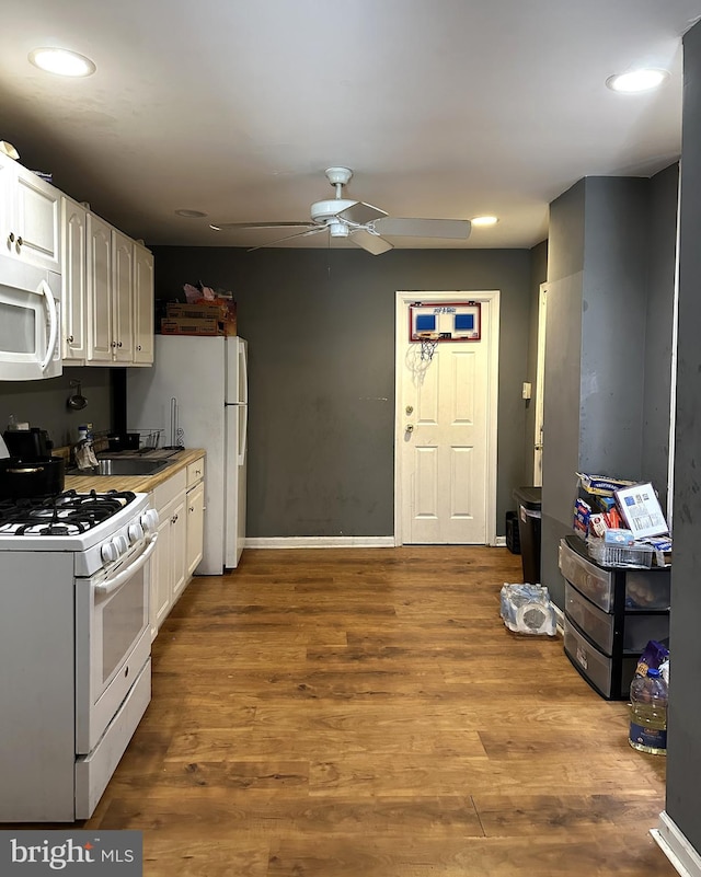 kitchen with white cabinetry, white appliances, ceiling fan, and light wood-type flooring