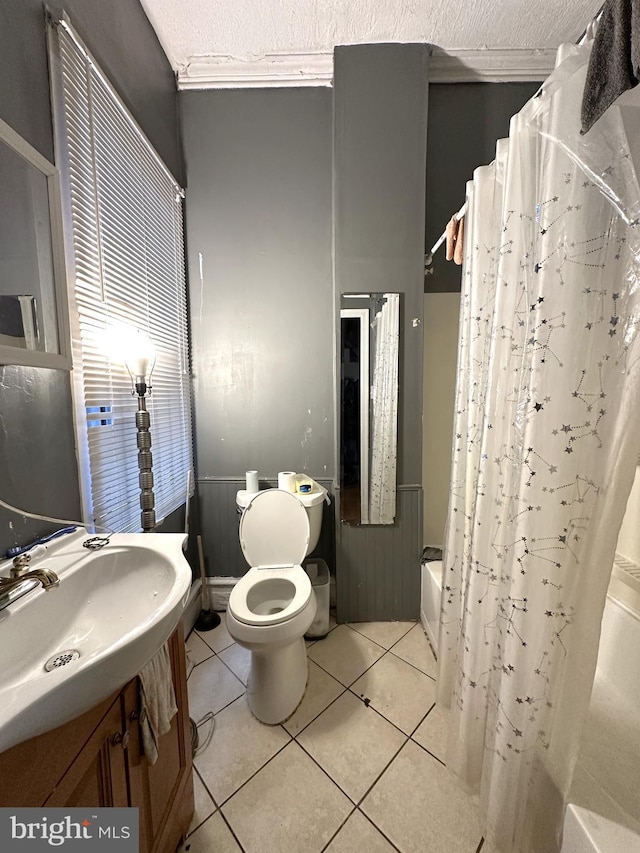 full bathroom with vanity, tile patterned floors, a textured ceiling, and toilet