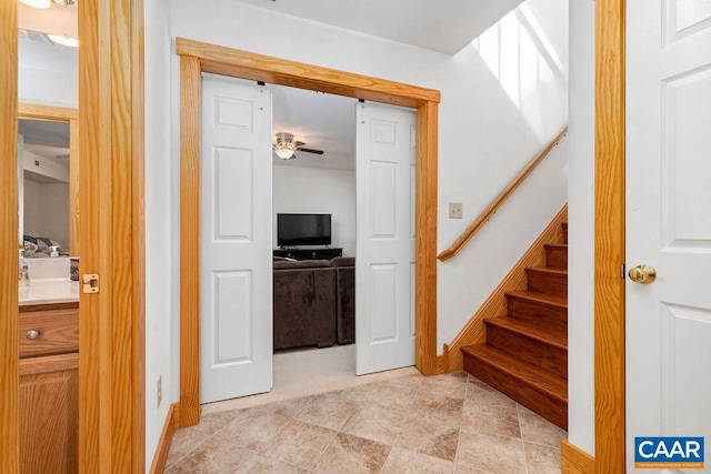 stairway with ceiling fan