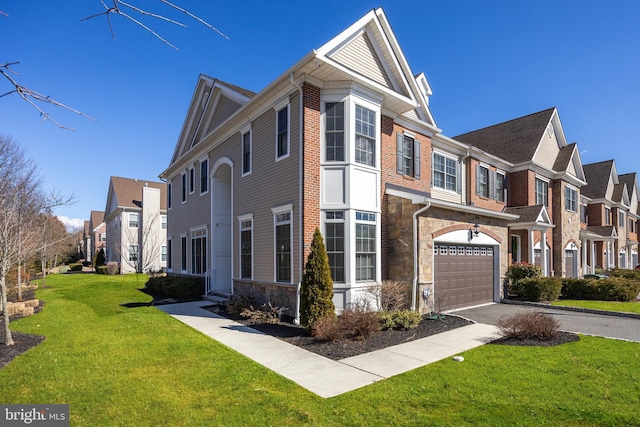 view of front of property with a front lawn, a residential view, a garage, stone siding, and driveway