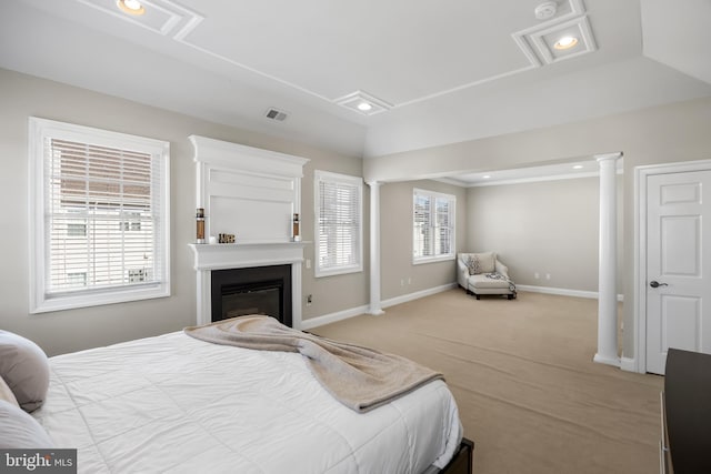 bedroom featuring multiple windows, decorative columns, and visible vents