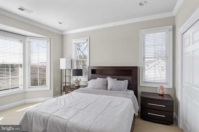 carpeted bedroom with visible vents, multiple windows, crown molding, and baseboards