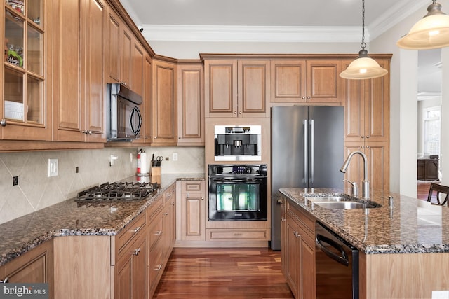 kitchen with dark wood finished floors, dark stone counters, ornamental molding, a sink, and black appliances