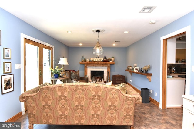 living room with a brick fireplace, visible vents, french doors, and baseboards