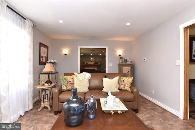 living room featuring baseboards and recessed lighting