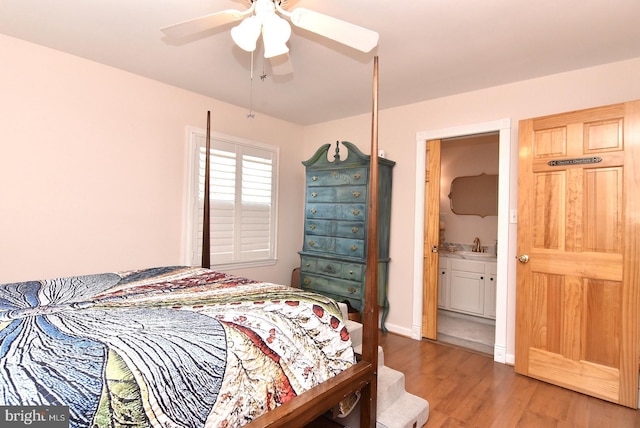 bedroom featuring ceiling fan, a sink, wood finished floors, and baseboards