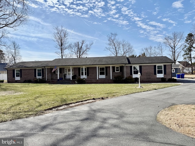 ranch-style home with brick siding and a front lawn