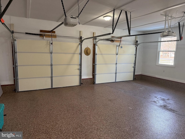 garage with baseboards and a garage door opener