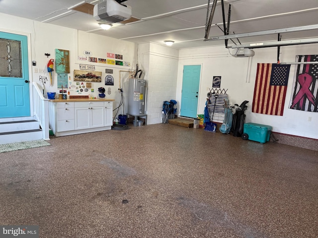 garage featuring a garage door opener, a workshop area, and electric water heater