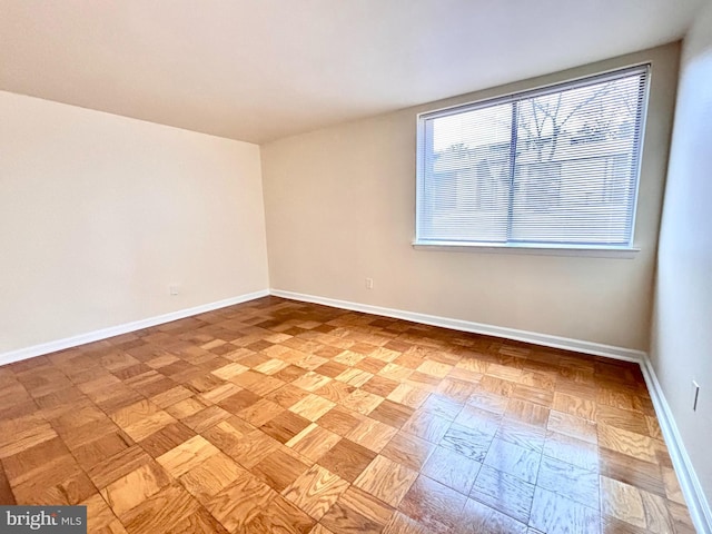 unfurnished room with light parquet flooring