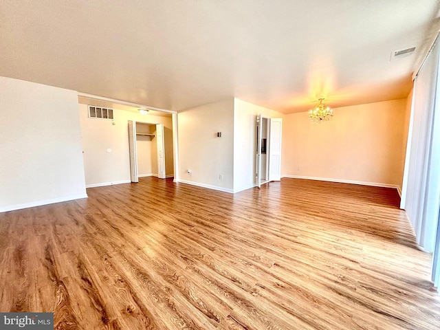 interior space featuring light hardwood / wood-style flooring and a notable chandelier