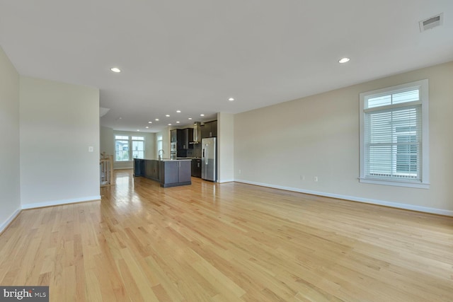 20765 Duxbury Ter, Ashburn, VA 20147 - unfurnished living room featuring light wood-type flooring and recessed lighting