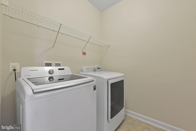 20765 Duxbury Ter, Ashburn, VA 20147 - laundry room featuring washer and clothes dryer and light tile patterned floors