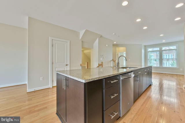 20765 Duxbury Ter, Ashburn, VA 20147 - kitchen with stainless steel dishwasher, light wood-style flooring, a kitchen island with sink, light stone countertops, and recessed lighting