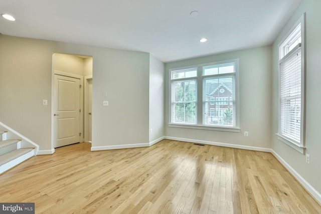 20765 Duxbury Ter, Ashburn, VA 20147 - spare room featuring light wood-type flooring, plenty of natural light, recessed lighting, and stairs