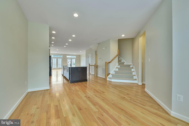 20765 Duxbury Ter, Ashburn, VA 20147 - unfurnished living room with light wood-style floors, recessed lighting, and stairs