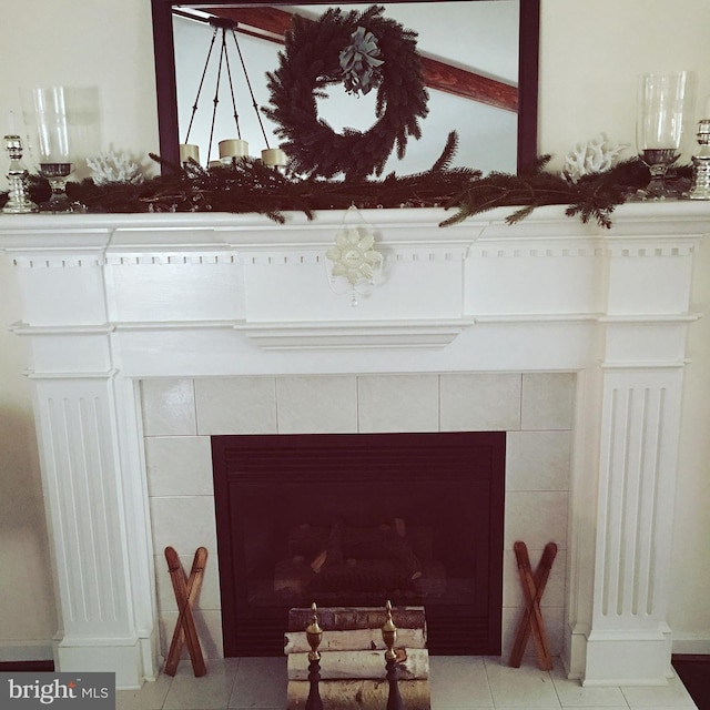 interior details featuring a tiled fireplace