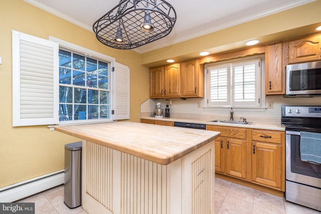 kitchen with a baseboard heating unit, a sink, a kitchen island, wooden counters, and appliances with stainless steel finishes