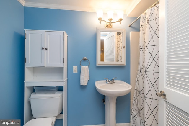 bathroom with ornamental molding, toilet, and curtained shower