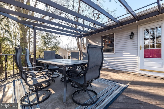 deck with outdoor dining area and a pergola