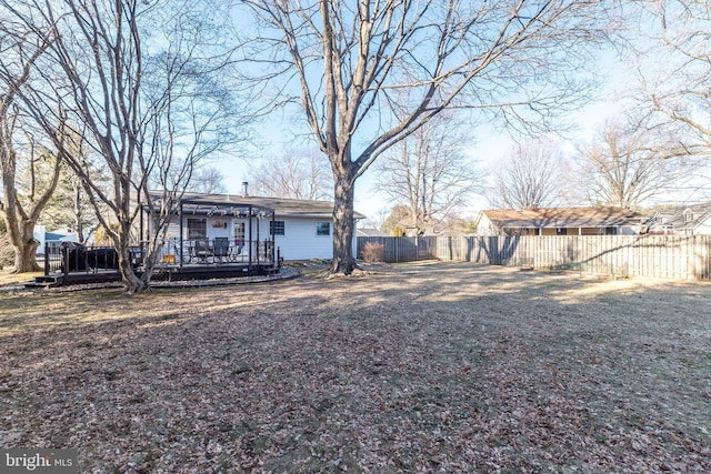 rear view of house with a deck and a fenced backyard