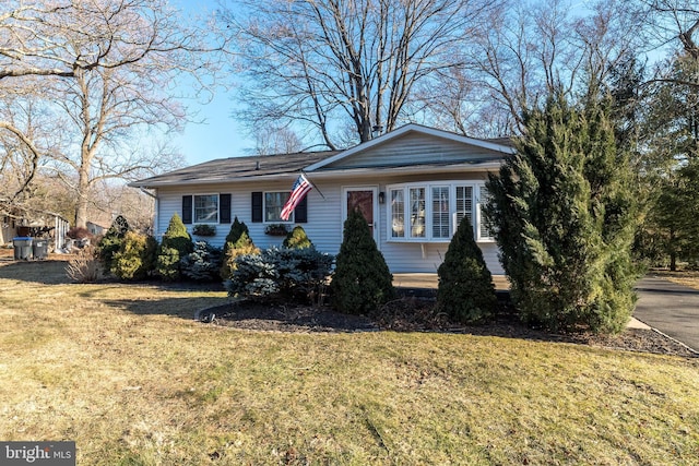 ranch-style house with a front lawn