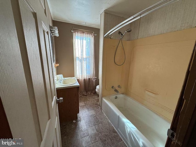 full bathroom featuring vanity, crown molding, washtub / shower combination, and toilet