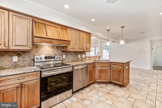 kitchen featuring sink, ornamental molding, appliances with stainless steel finishes, kitchen peninsula, and pendant lighting