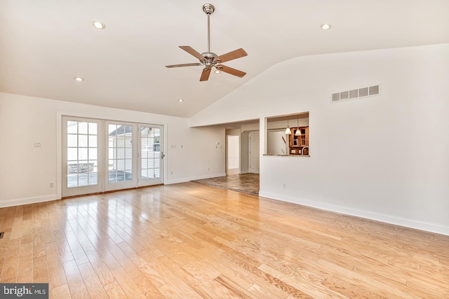 unfurnished living room with high vaulted ceiling, ceiling fan, and light wood-type flooring