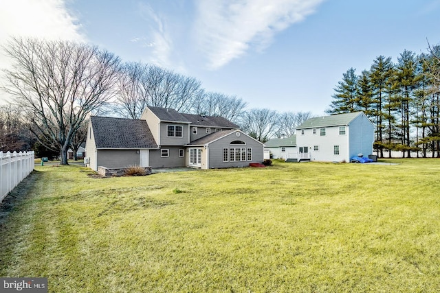 rear view of house with a lawn