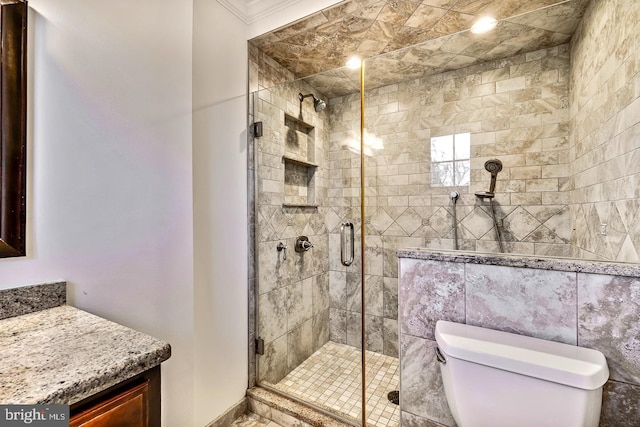 bathroom with a shower with shower door and toilet