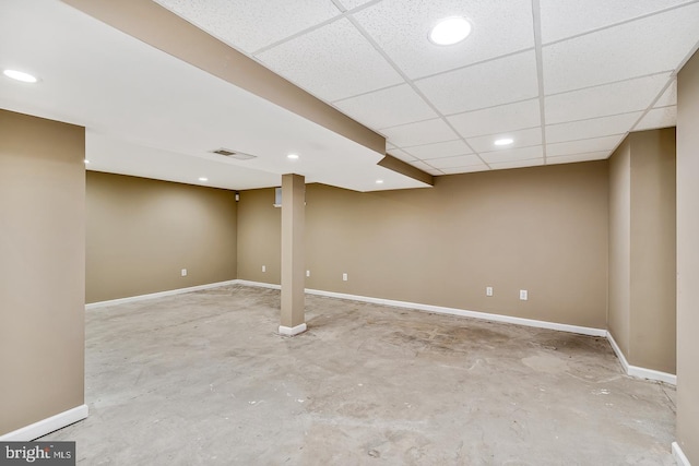 basement with a paneled ceiling