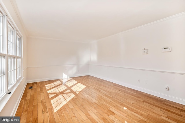 spare room with light hardwood / wood-style flooring and ornamental molding