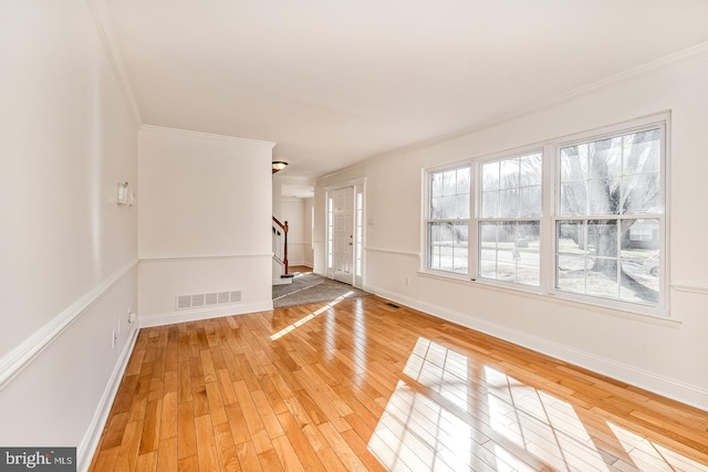 interior space featuring wood-type flooring and crown molding