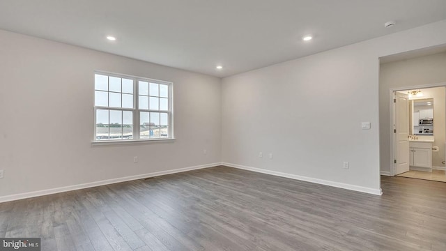 spare room with wood-type flooring