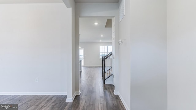 hallway with hardwood / wood-style flooring