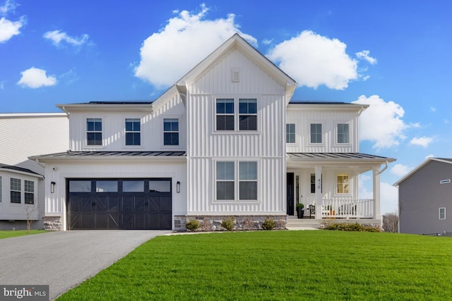 modern inspired farmhouse with driveway, a porch, a standing seam roof, and a front lawn