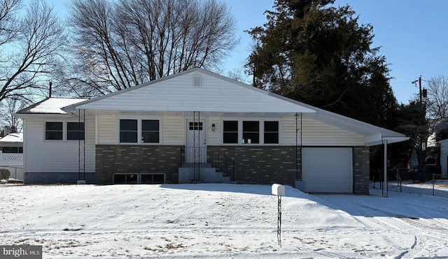 view of front of home featuring stone siding and an attached garage