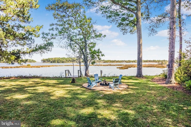 view of yard featuring a water view and an outdoor fire pit