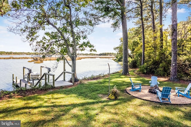 view of yard with a boat dock and a water view