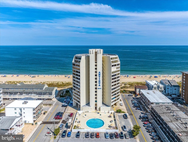 drone / aerial view featuring a water view and a beach view