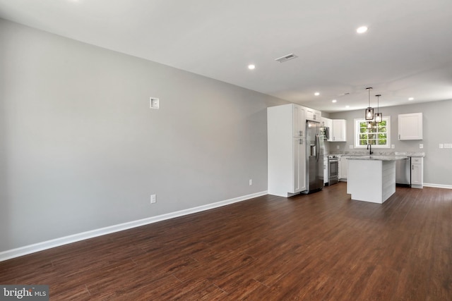 unfurnished living room with dark wood-type flooring