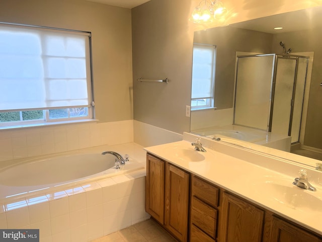 full bathroom featuring a shower stall, a bath, double vanity, and a sink