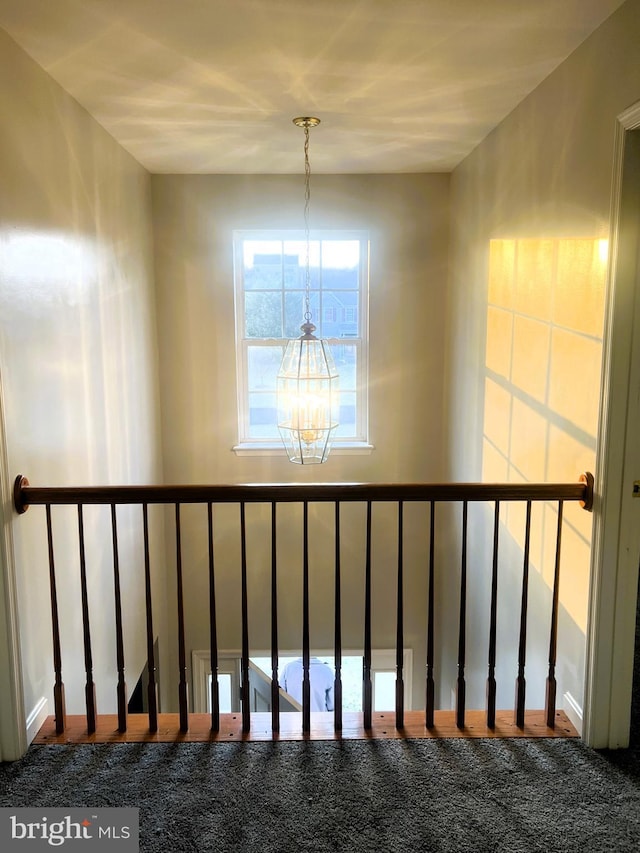 stairs featuring an inviting chandelier