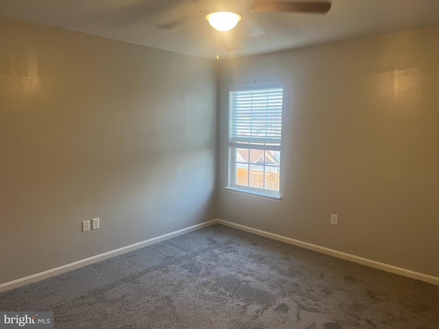 empty room featuring baseboards, a ceiling fan, and carpet floors