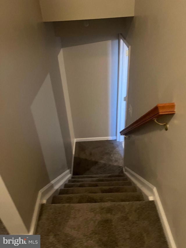 stairway featuring baseboards