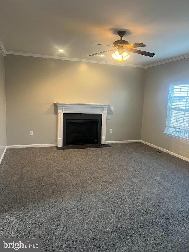 unfurnished living room featuring baseboards, a fireplace with flush hearth, ceiling fan, ornamental molding, and dark colored carpet